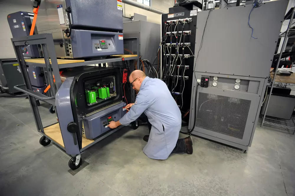 What Is Battery Load Testing? Reliability & Savings A lab technician performs a controlled battery load test on multiple battery modules - What Is Battery Load Testing? Reliability & Savings