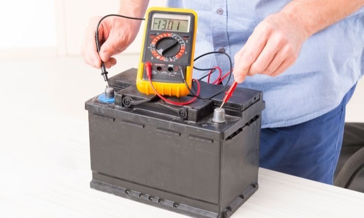 Engineer analyzing battery wattage metrics on a digital display Engineer analyzing battery wattage metrics on a digital display